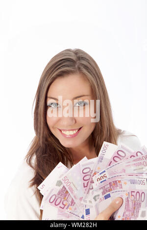 Giovane donna azienda molte banconote in mano Foto Stock