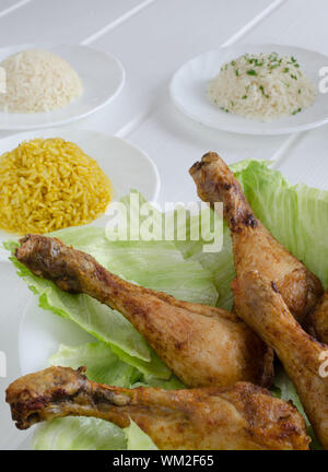 Grigliata di cosce di pollo con riso tre su legno bianco Foto Stock