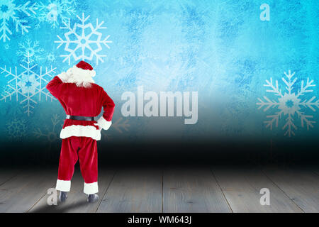 Babbo Natale contro il simbolo del fiocco di neve lo sfondo su pannelli del pavimento Foto Stock