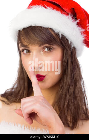 Festive brunette mantenendo un segreto su sfondo bianco Foto Stock