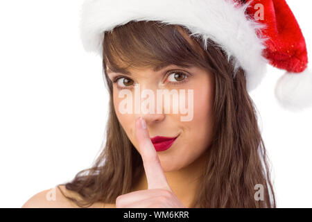 Festive brunette mantenendo un segreto su sfondo bianco Foto Stock