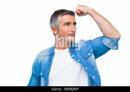 Uomo con i capelli grigi tensore muscoli del braccio su sfondo bianco Foto Stock