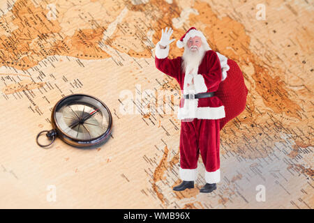 Santa onde per la telecamera contro la mappa del mondo con la bussola mostra Asia meridionale Foto Stock