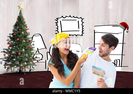 Felice coppia giovane pittura insieme e ridere contro soggiorno schizzo a natale Foto Stock