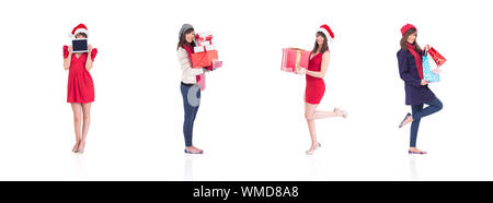 Immagine composita di felice brunette in abbigliamento invernale azienda borse per lo shopping Foto Stock