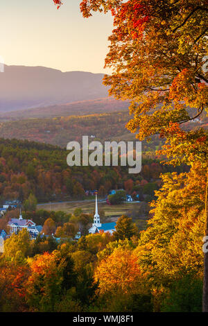 Affacciato su un tranquillo New England comunità la chiesa ed il villaggio in un autunno tramonto, Stowe Vermont, USA Foto Stock