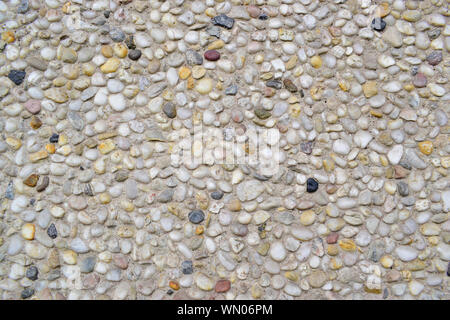Grigio materiale lapideo decorato sul muro di cemento. Primo piano della texture grigio Sfondo. Foto Stock