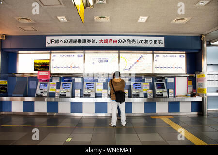 Il popolo giapponese e i viaggiatori stranieri attendere passeggeri e stare in coda per comprare il biglietto del treno MRT da auto distributore automatico a Katama Station su Marzo Foto Stock