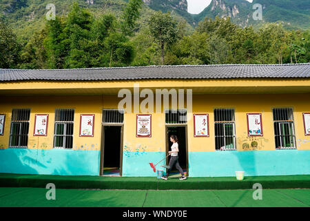 (190906) -- CHONGQING, Sett. 6, 2019 (Xinhua) -- insegnante di volontariato Mu Yi fa pulizia dopo la scuola a Lianhua scuola primaria di Luzi Village, Chengkou County, a sud-ovest della Cina di Municipalità di Chongqing, Sett. 2, 2019. Mu Yi, un 25-anno-vecchio insegnante PE dalla Municipalità di Chongqing, offre una settimana di volontariato servizio di insegnamento e le opere di un maestro locale Tao Yao in questo remoto villaggio. Nella scuola dove solo due di secondo grado studenti e 18 bambini di età prescolare studio, Mu Yi e Tao Yao anche fare altri lavori come mandanti, detergenti, i cuochi e repairwomen. Mu Yi insegna ai bambini sport, arte e musica Foto Stock