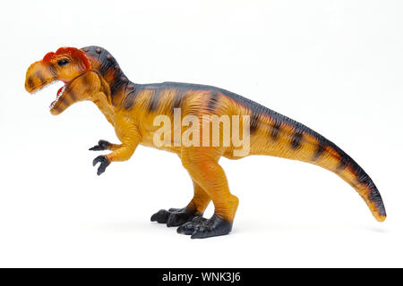 Lato sul colpo di un giocattolo Tyrannosaurus Rex isolato e girato su sfondo bianco Foto Stock