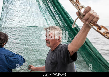 I pescatori commerciali lavorando sul ponte di un peschereccio da traino in Carolina del Sud Foto Stock