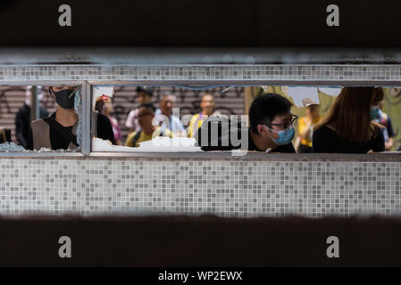 Hong Kong, Cina. 06 Sep, 2019. I manifestanti in peek all'ingresso della stazione di indagine il danneggiamento durante la dimostrazione.Anti-governo manifestanti sono scesi in strada di nuovo nell'ultimo round di anti-dimostrazioni di estradizione. I manifestanti di mira la zona intorno a cui il 31 agosto MTR si è verificato un incidente, vandalizing varie stazione MTR di ingressi. La polizia antisommossa finalmente è arrivato e ha condotto una operazione di dispersione. Credito: SOPA Immagini limitata/Alamy Live News Foto Stock