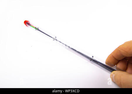 Le punte delle canne da pesca su uno sfondo bianco. Posto per il testo. Foto Stock