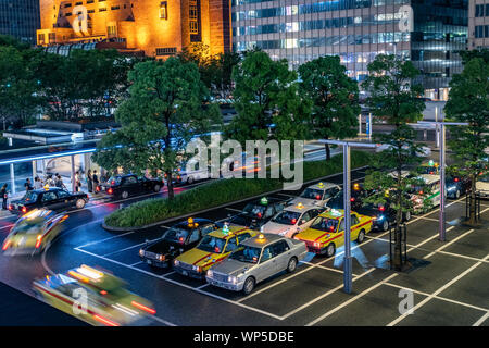 I taxi stanno per fare la fila per prendere i passeggeri alla stazione ferroviaria di Fukuoka in Giappone Foto Stock