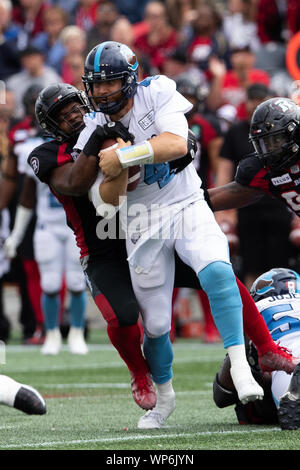 Ottawa, Canada. 07Th Sep, 2019. Toronto Argonauts quarterback McLeod Bethel-Thompson (4) viene affrontato da Ottawa Redblacks De'Chavon Hayes (34) durante il CFL gioco tra Toronto Argonauts e Ottawa Redblacks a TD Place Stadium di Ottawa in Canada. Daniel Lea/CSM/Alamy Live News Foto Stock