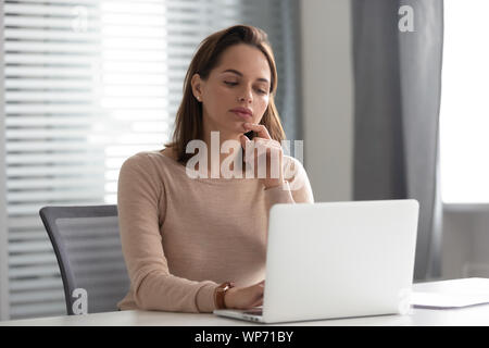 Grave ceo femmina pensando più difficile la soluzione del problema in ufficio. Foto Stock