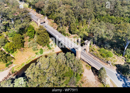 Hampden sospensione ponte sul fiume di canguro in Kangaroo Valley Regional paese attraverso deep creek coperto dalla gengiva-tree bosco visto da sopra Foto Stock