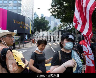 Hong Kong, Cina. 08 Sep, 2019. Manifestanti ondata di Hong Kong e bandierine americane come polizia guardare da fino alla strada durante la dimostrazione.Migliaia di manifestanti hanno marciato per gli Stati Uniti Consolato Generale a sostegno della Hong Kong diritto umano agisce. Manifestanti hanno sventolato bandierine americane, esposti vari cartelli e gridato slogan per chiedere il coinvolgimento degli Stati Uniti. Alla fine la violenza scoppiata come manifestanti vandalizzato alcune stazione MTR di entrate, e la polizia ha in seguito effettuato una operazione di dispersione. Credito: SOPA Immagini limitata/Alamy Live News Foto Stock