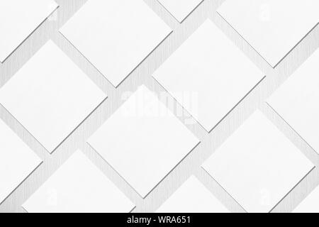 Molti vuoto quadrato bianco business card mockups con le ombre morbide giacente diagonalmente sul neutro grigio chiaro sfondo a trama. Appartamento laico, vista dall'alto. Aprire c Foto Stock