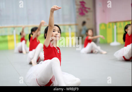 Giovani cinesi i bambini imparare danza presso una scuola durante le vacanze estive in Danzhai county, Qiandongnan Miao e Dong prefettura autonoma, a sud-ovest Foto Stock