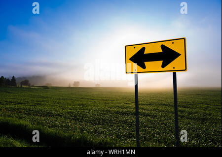 Direzionale segno su strada di fronte ad un campo di mais, Stowe Vermont, USA. Foto Stock