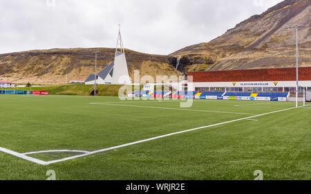 OLAFSVIK, SNAEFELLSNES PENINSULA, Islanda - Campo di calcio e la chiesa, nella piccola cittadina sulla costa. Foto Stock