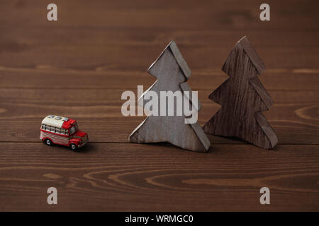 Alberi di legno con un auto in miniatura closeup isolato sul tavolo Foto Stock