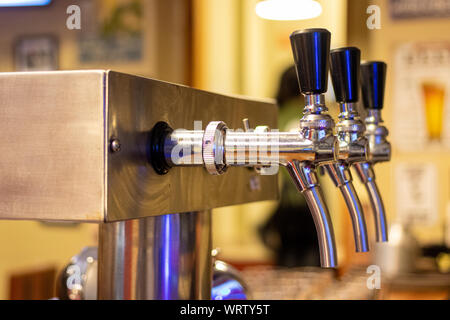 Mano del barista versando una grande birra lager in tap. Foto Stock