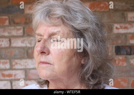 Ritratto di una donna matura sentimento di tristezza con gli occhi chiusi Foto Stock