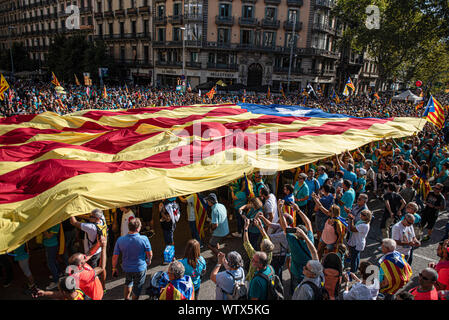Barcellona, Spagna. Undicesimo Sep, 2019. Manifestanti tenere una grande indipendenza bandiera attraverso la dimostrazione sulla Giornata Nazionale della Catalogna, che è stato organizzato dal catalano Assemblea Nazionale. Credito: SOPA Immagini limitata/Alamy Live News Foto Stock