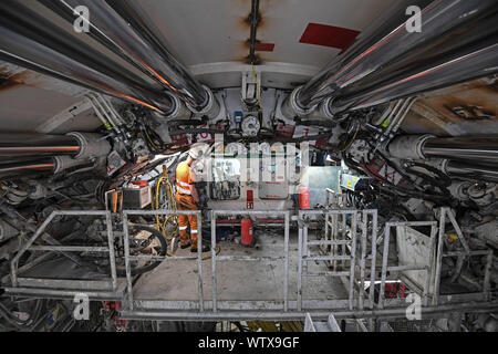 Un ingegnere lavora alla estremità anteriore di una macchina alesatrice lo scavo di una sezione della Thames Tideway Tunnel in Londra. Foto Stock