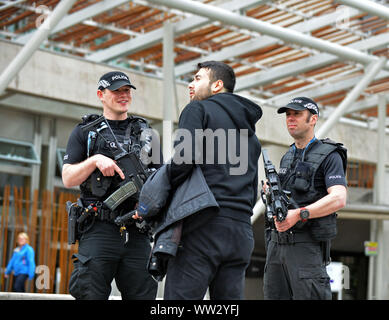 JON SAVAGE FOTOGRAFIA 24MAGGIO 2017 poliziotti armati pattugliano il parlamento scozzese di Edimburgo come la sicurezza è aumentato in tutta la città. Foto Stock