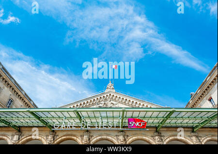 Parigi, Francia - Luglio 14, 2011: Tetto della Gare de l'Est stazione ferroviaria SNCF con statua di Strasburgo e tricolore francese bandiera nazionale e cielo blu chiaro Foto Stock