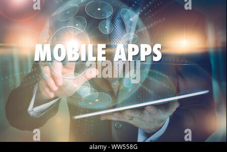 A mano selezionando un Mobile Apps concetto aziendale su un avveniristico il display del computer. Foto Stock