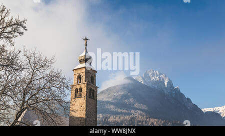 Il campanile della chiesa antica di San Cipriano (St. Cipriano) in Taibon Agordino, sullo sfondo il Monte Agner, Belluno, Veneto, Italia Foto Stock