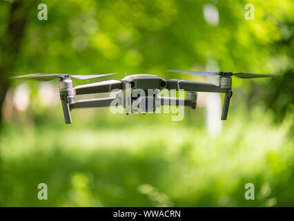 Flying drone con fotocamera passando all'interno di un forrest, sfondo naturale Foto Stock