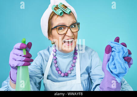 Donna delle pulizie divertente. Anziani funny casalinga ingannare circa con una scopa. Corpo pieno isolato. Pulizia comico lady, vecchia donna funky Foto Stock