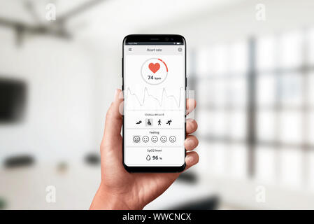 Misurazione della frequenza cardiaca app su smart phone in mano. Concetto di misurazione in ufficio. Moderno design piatto il concetto di app. Foto Stock