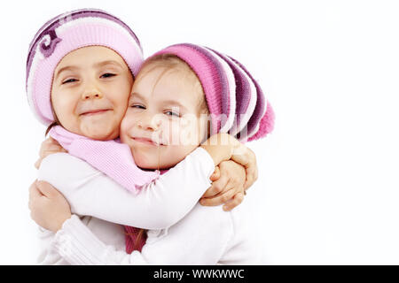 Ritratto di bella abbracciando kid ragazze indossano abiti invernali Foto Stock