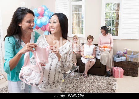 Gli amici sorseggiando un bambino, doccia Foto Stock