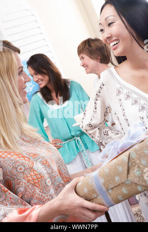 Gli amici sorseggiando un bambino, doccia Foto Stock