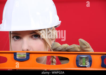 Femmina lavoratore manuale con livella a bolla Foto Stock