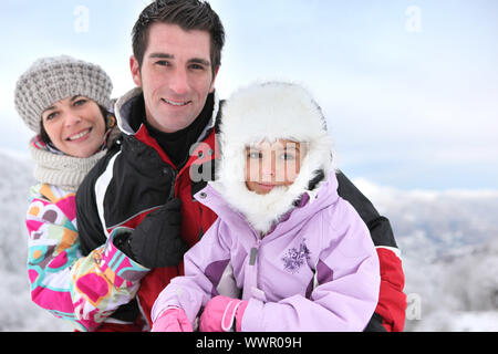 Famiglia in snowsuits Foto Stock
