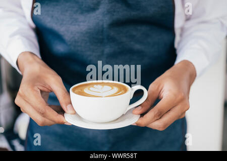 Giovane proprietario di caffè cafe servizio il cliente. Small business e proprietario concetto aziendale. Foto Stock
