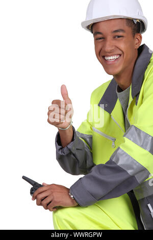 Lavoratore edile con un walkie-talkie Foto Stock