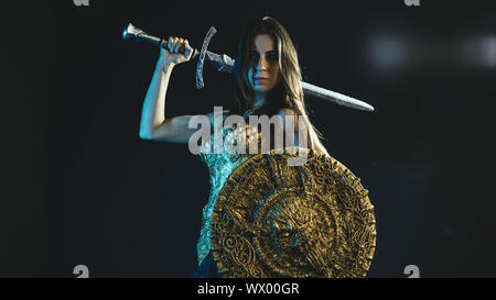 Storia valkyrie guerriero, donna con golden armor rivestire di ferro e grande guerriero spada Foto Stock