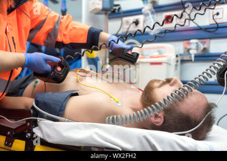 Emergenza Medica in ambulanza. Medico di emergenza utilizzando il defibrillatore Foto Stock