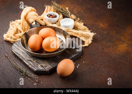 Fresco di uovo crudo su una padella, pietra o calcestruzzo sfondo. Foto Stock