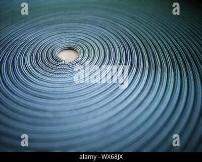 Tappeto a spirale realizzata con corda di arrampicata. Filo pavimento moquette. Foto Stock