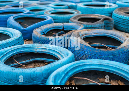 Blu pneumatici in disuso sul terreno Foto Stock